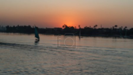 Photo for Blurred sunset landscape of Nile river with felucca sailboat Travel Egypt Nile Cruise - Royalty Free Image