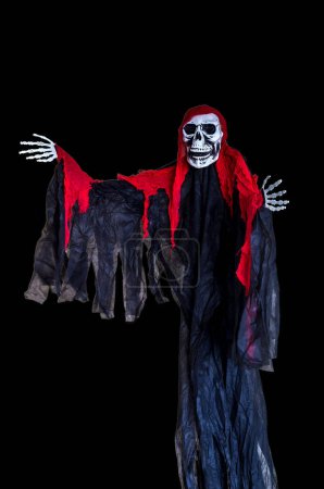 A Halloween skeleton dressed in black costume with red clo