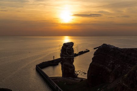 Beautiful sunset over North sea and famous rock Long Anna on the island Heligoland. Germany.