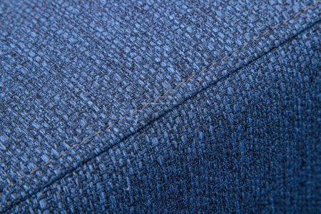 Textured blue furniture fabric with stitching close-up