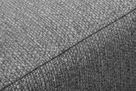 Textured grey furniture fabric with stitching close-up