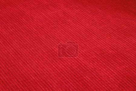 Textured corduroy furniture fabric in red colors close-up