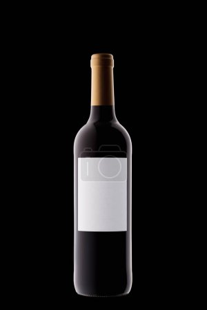 Photo for Bottle of wine with a white label with beautiful highlights on a black background close-up - Royalty Free Image