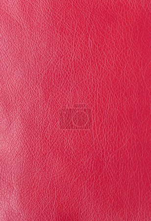 Texture of genuine leather, artificial leatherette red background close-up