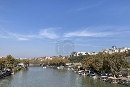 Photo for The magnificent flow of the Kura River seen from the peace bridge in Georgia Tobilisi - Royalty Free Image