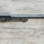 hunting rifle isolated on wooden background