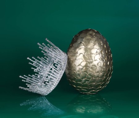 golden dragon egg and crown isolated on green background