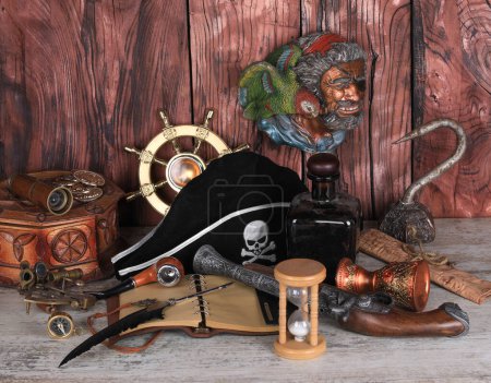 Photo for Pirate accessories on a wooden table - Royalty Free Image