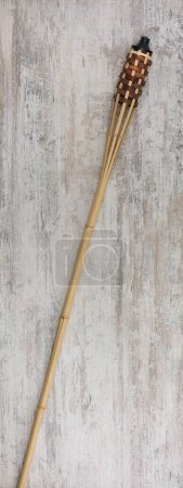 Foto de Bamboo torch on wooden background - Imagen libre de derechos