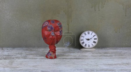 Photo for Red wooden african mask on a wooden table - Royalty Free Image
