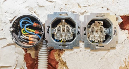 Photo for Not completely walled in flush-mounted sockets in the wall during wiring - Royalty Free Image