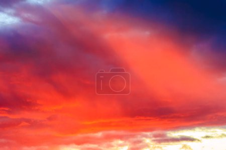 Photo for Colorful sunset in orange yellow and blue over orchard meadows in Siebenbrunn near Augsburg - Royalty Free Image