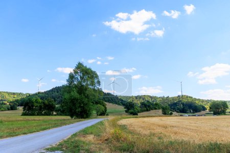 Photo for View over the forests in Rems-Murr district near Geildorf on the Swabian Alb in Germany to a wind farm with wind turbines - Royalty Free Image