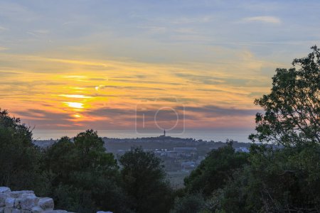 Photo for View from the ruins of the castle Kula Trnina to the town Rovij in Istria at sunset in the back light - Royalty Free Image