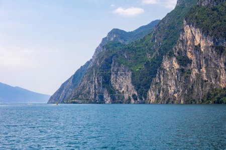 Photo for Wooded mountain top and rock wall on the northern shore of Lake Garda in Italy - Royalty Free Image