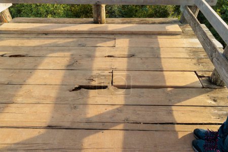 Photo for Crumbling patched wooden floor of a viewing platform at Limski canal near Rovinj in Croatia - Royalty Free Image