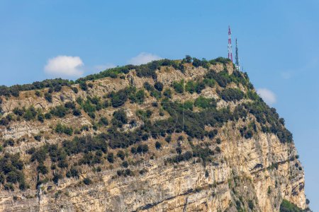 Photo for Wooded mountain top and rock wall on the northern shore of Lake Garda in Italy - Royalty Free Image