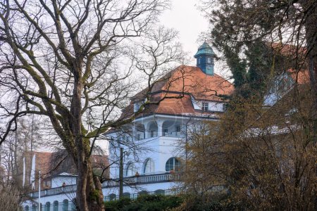 Photo for Old stately house in Seeshaupt in Bavaria at the Starnberg Lake on a slightly cloudy winter day - Royalty Free Image
