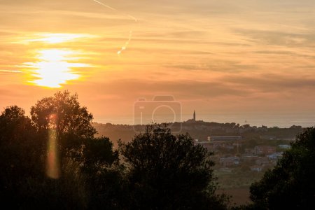 Photo for View from the ruins of the castle Kula Trnina to the town Rovij in Istria at sunset in the back light - Royalty Free Image