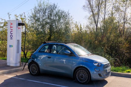 Photo for Slovenja Koper 29-10-2022, a blue Fiat 500 electric convertible at a fast charging station charging the battery - Royalty Free Image