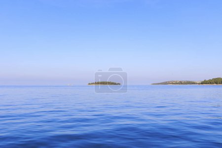 Photo for Three flat islands on a sunny day with blue sky in the sea near Rovinj in Croatia - Royalty Free Image