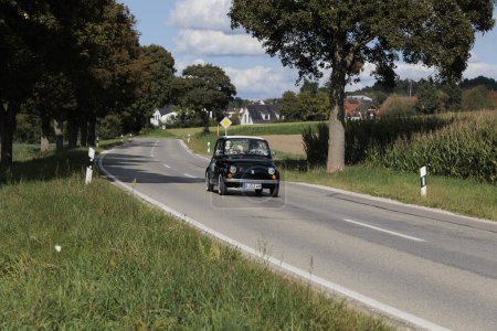 Photo for Black Fiat 500 classic car on the road near Blumenthal as a participant of the Fuggerstadt Classics, Augsburg September 24, 2023, Augsburg, Germany. - Royalty Free Image