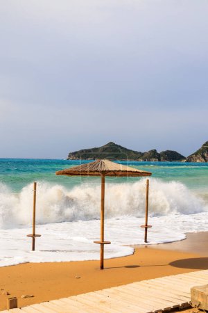 Photo for The sandy beach of Agios Georgios on the island of Corfu on a stormy day with high waves - Royalty Free Image