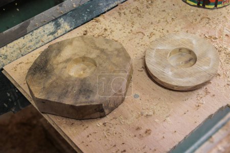 Téléchargez les photos : Étagères de rangement avec ébauches en bois d'olivier préparées pour le séchage dans l'atelier d'un sculpteur en bois d'olivier - en image libre de droit