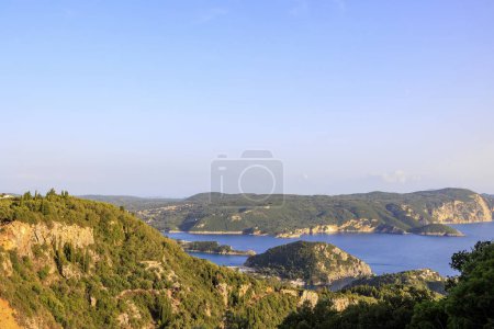 Photo for View in the evening under a blue sky over the bay and the sea at Paleokastrtitsa on the island of Corfu - Royalty Free Image