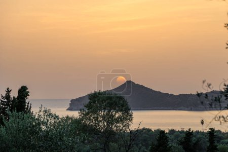 Photo for Sunset over the sea and the bay of Agios Georgios on the island of Corfu - Royalty Free Image