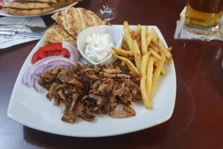 Photo for Greek gyros plate with chips and tsatziki on the island of Corfu - Royalty Free Image