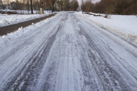 Téléchargez les photos : Surface couverte de neige et de glace noire sur une route à Siebenbrunn près d'Augsbourg en hiver - en image libre de droit