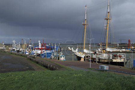 Photo for The harbour in the city of Den oever on a stormy day with rain and clouds, Netherlands, Den Helder, 24.3.2024 - Royalty Free Image