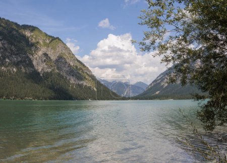 Photo for View over the lake Heiterwanger See near Heiterwang in Austria on a sunny day with blue sky and cumulus clouds. - Royalty Free Image