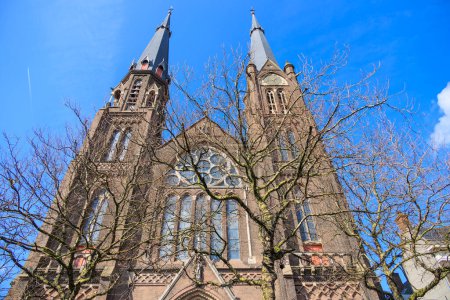 The towers of the Maria van Jessekerk church on a spring day with a blue sky in the Dutch city of Delft