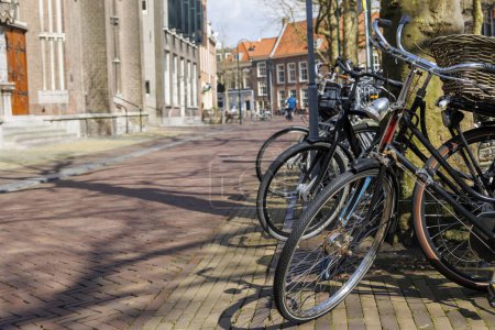 Bicycles parked at a bicycle stand in front of the Maria van Jessekerk church in the Dutch city of Delft in spring