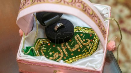Diamond Ring and Imam Zamin in a Pink Basket for the Bride.