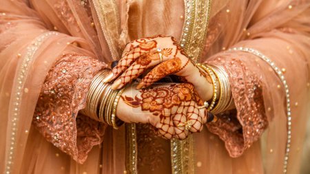 Photo for Beautiful Hands Of a Desi Bride with jewelry and Henna on it. - Royalty Free Image