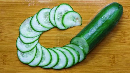 Green Cucumber is Perfectly Cut and Placed by a Chef.