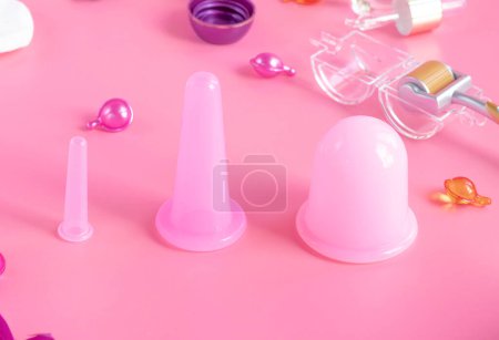 Photo for Silicone vacuum jars for anti-cellulite massage color pink on a pink background. Self-massage at home. for home use - Royalty Free Image