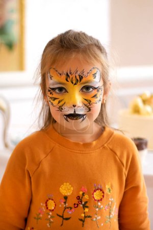 Photo for Childrens makeup face paint drawings Girls face painting. Little girl having face painted on birthday party. closed eyes. High quality photo - Royalty Free Image