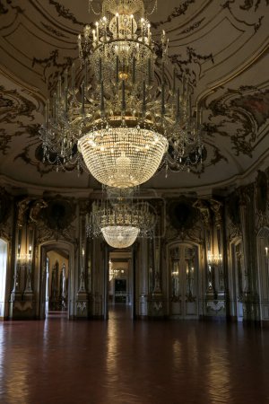 Photo for Queluz, Lisbon, Portugal- January 17, 2023: Crystal chandelier, furniture and refined gilded wood decoration of the Beautiful National Palace of Queluz, Sintra - Royalty Free Image