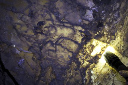 Photo for Illuminated by flashlight rock of Lapis Specularis in the roman mine in The Sanabrio caves in Cuenca region, Spain - Royalty Free Image