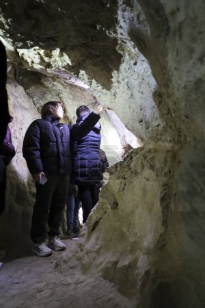 Photo for Cuenca, Castile-La Mancha, Spain- December 10, 2023: People visiting the Lapis Specularis roman mine in The Sanabrio caves in Cuenca region, Spain - Royalty Free Image