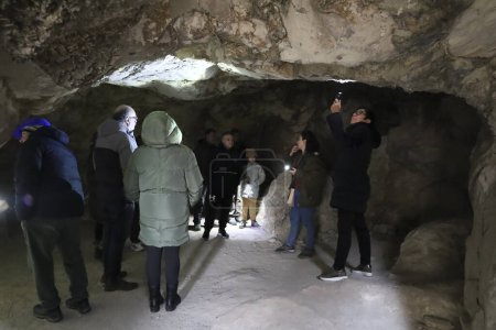 Photo for Cuenca, Castile-La Mancha, Spain- December 10, 2023: People visiting the Lapis Specularis roman mine in The Sanabrio caves in Cuenca region, Spain - Royalty Free Image