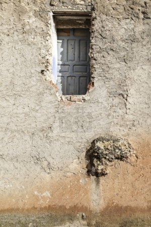 Photo for High and inaccessible blue wooden door on facade - Royalty Free Image