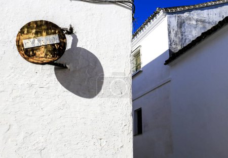 Old and rusty no entry road signal on white facade in Andalusia, Spain