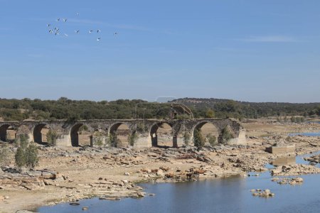 Remains of the Historical Ajuda bridge over the Guadiana River, located between the border of Spain and Portugal