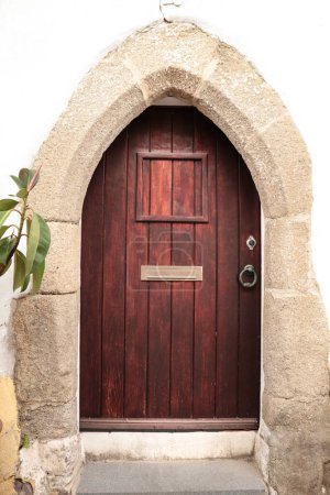 Wooden door and stone threshold in Elvas town, Portugal