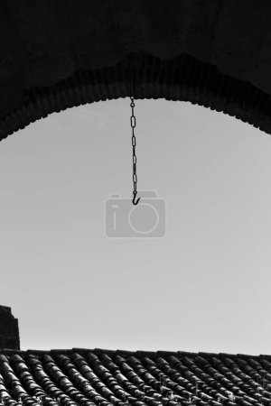 Iron chain hanging from The Miradeiro Arch in Elvas town, Portugal